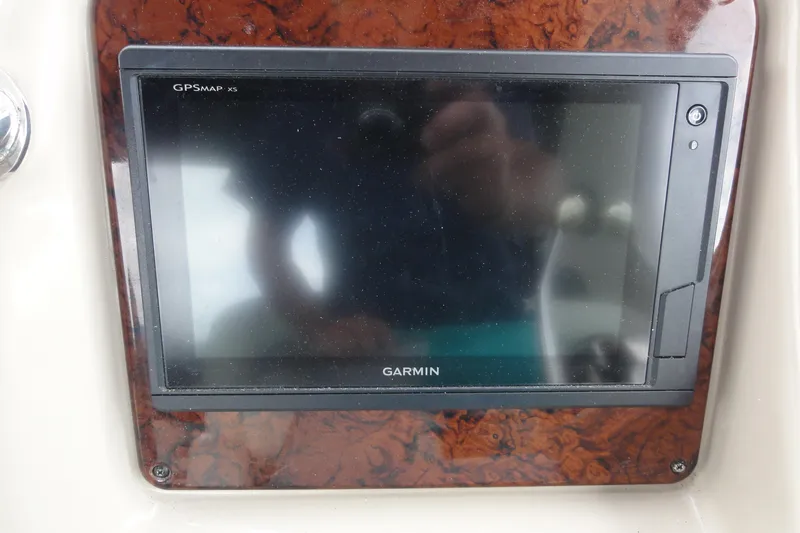 Slide: The Image of Garmin GPSMAP xs on 2004 Sea Ray 320 Sundancer dashboard, wood paneling. - 13