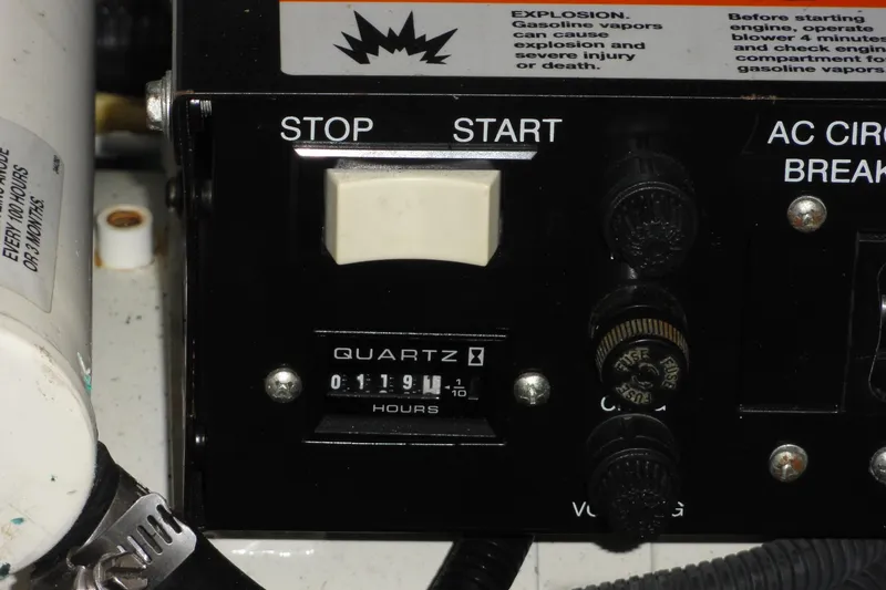 Slide: The Image of Control panel of a 2004 Sea Ray 320 Sundancer with hour meter and switches. - 27