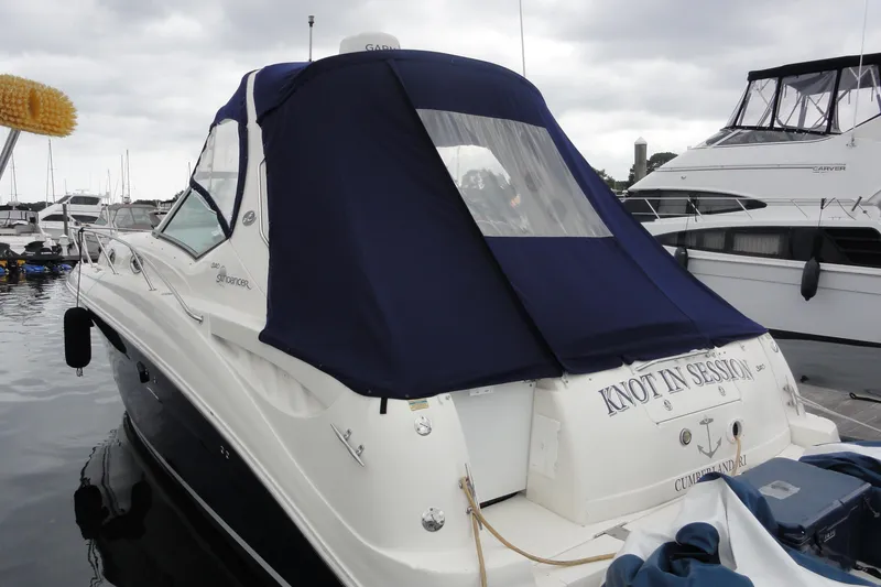 Slide: The Image of 2004 Sea Ray 320 Sundancer docked with blue canvas cover, overcast sky. - 3