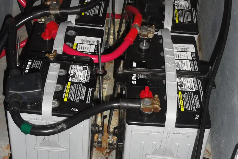 Slide: The Image of Battery compartment of a 2004 Sea Ray 320 Sundancer with multiple connected batteries. - 30