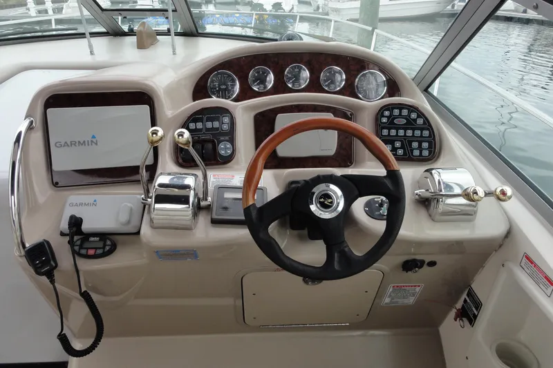 Slide: The Image of Cockpit of 2004 Sea Ray 320 Sundancer with Garmin navigation system and steering wheel. - 8