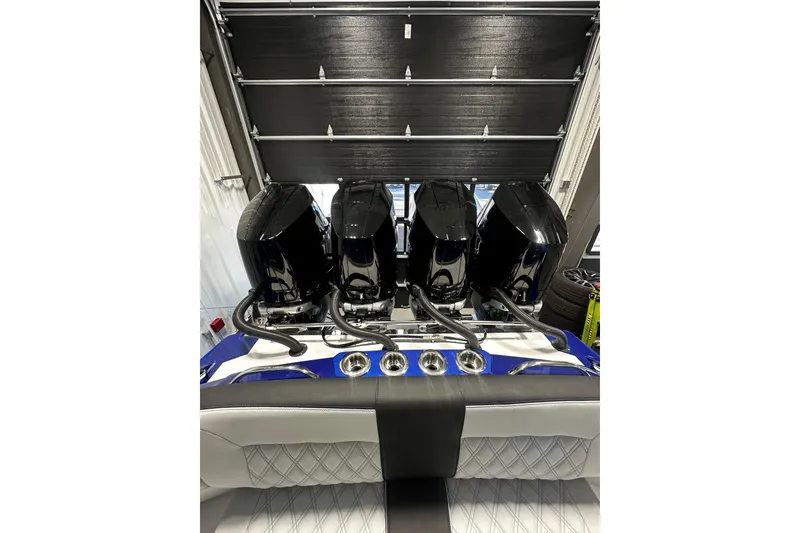 Slide: The Image of 2026 Nor-Tech 390 Sport Center Console with four powerful outboard engines in a garage setting. - 15