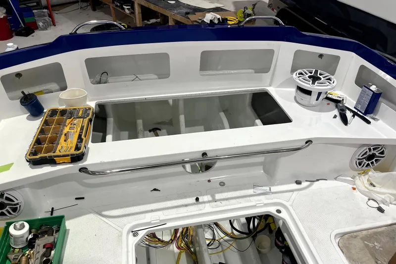 Slide: The Image of Interior view of 2026 Nor-Tech 390 Sport Center Console boat under maintenance. - 22
