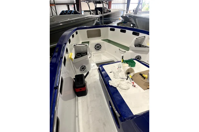 Slide: The Image of 2026 Nor-Tech 390 Sport Center Console interior with seating and storage compartments. - 23
