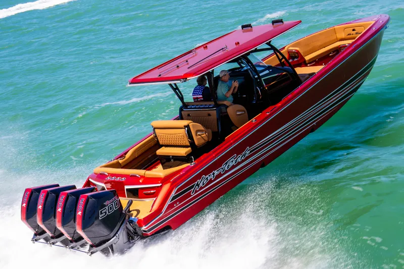 Slide: The Image of 2026 Nor-Tech 390 Sport Center Console in vibrant orange cruising on open water. - 25