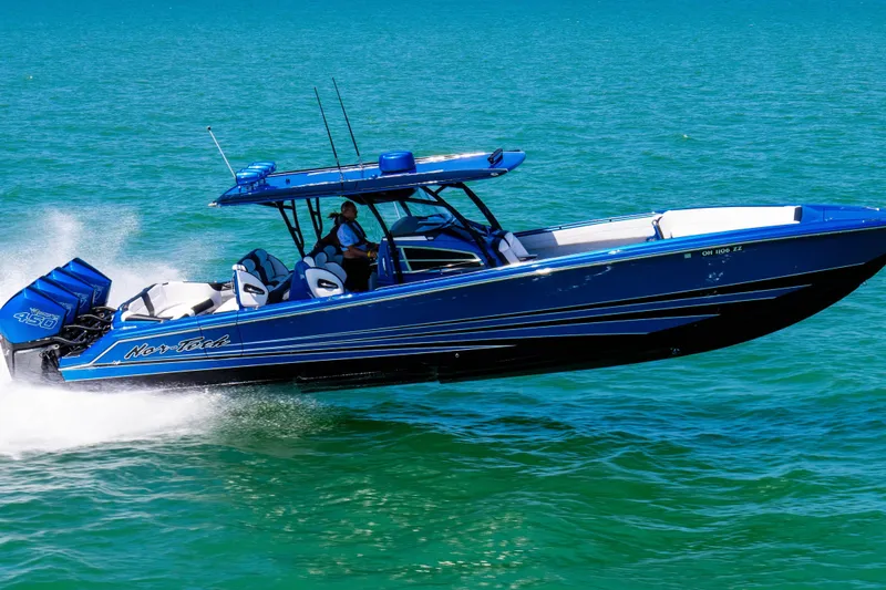 Slide: The Image of 2026 Nor-Tech 390 Sport Center Console boat speeding on open water. - 27