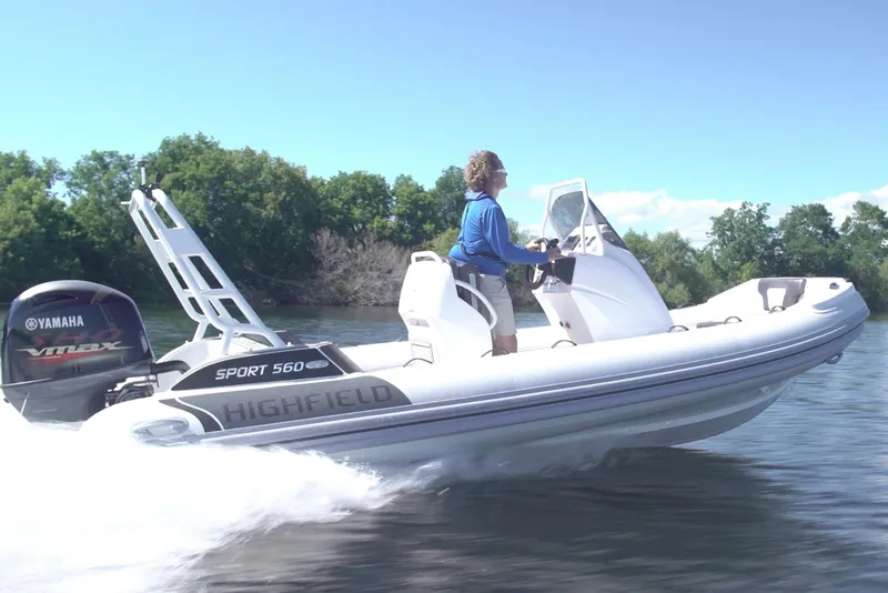 Slide: The Image of 2026 Highfield Sport 560 boat cruising on a lake with Yamaha engine. - 0