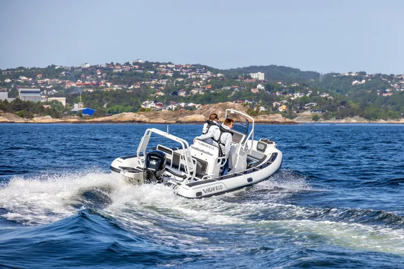 Slide: The Image of 2026 Highfield Sport 560 boat cruising on open water near a scenic coastline. - 6
