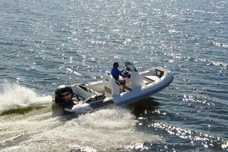 Slide: The Image of 2026 Highfield Sport 560 boat cruising on sparkling water. - 7