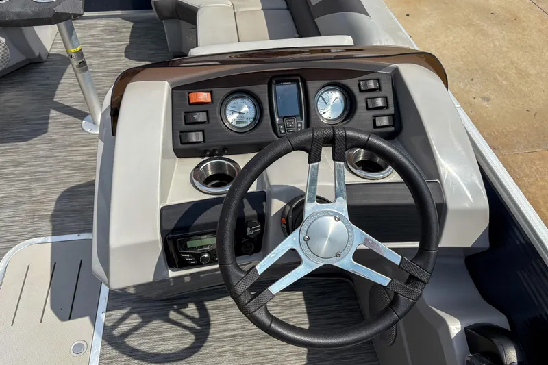 Slide: The Image of Steering console of 2022 Bennington SX 22 boat with gauges and controls. - 10