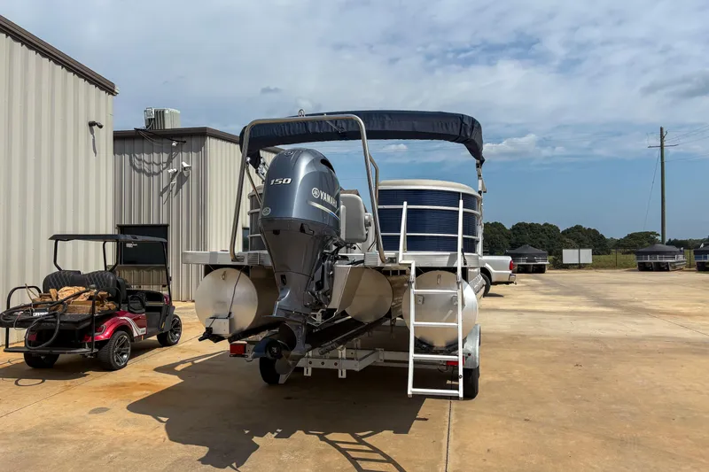 Slide: The Image of 2022 Bennington SX 22 pontoon boat with Yamaha engine in a parking lot. - 4