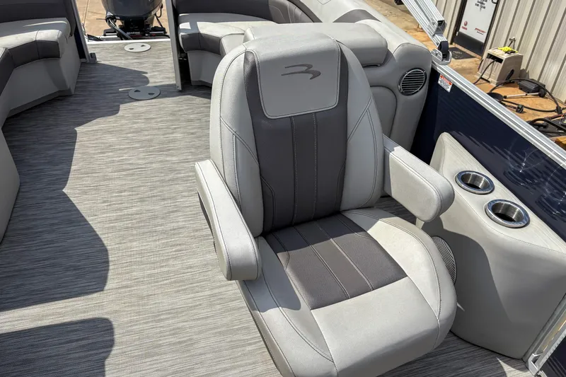 Slide: The Image of 2022 Bennington SX 22 boat interior with plush seating and cup holders. - 7