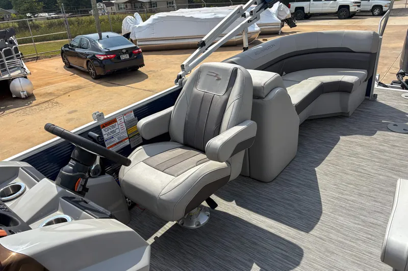 Slide: The Image of 2022 Bennington SX 22 boat interior with captain's chair and seating area. - 8