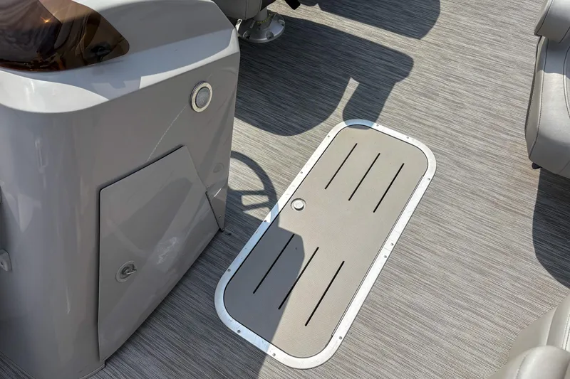 Slide: The Image of 2022 Bennington SX 22 boat interior with sleek flooring and storage compartment. - 9