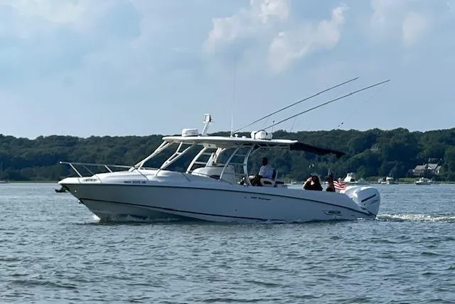 Slide: The Image of 2006 Boston Whaler 320 Outrage Cuddy Cabin cruising on a scenic lake. - 10