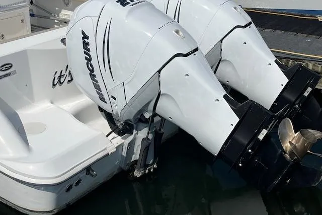 Slide: The Image of 2006 Boston Whaler 320 Outrage Cuddy Cabin with twin Mercury outboard engines. - 12