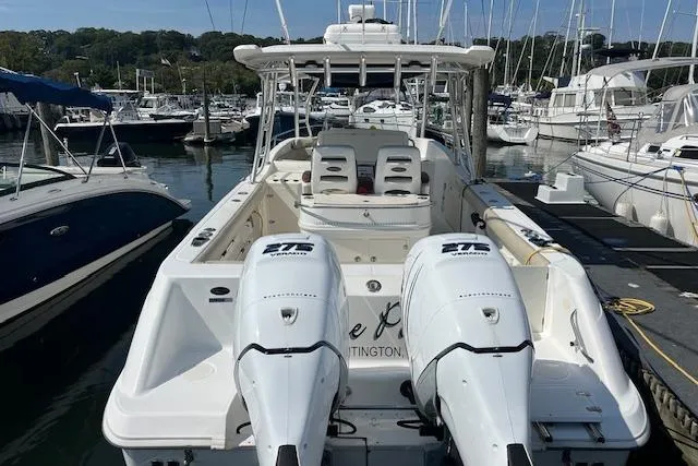 Slide: The Image of 2006 Boston Whaler 320 Outrage Cuddy Cabin docked at marina with twin engines. - 13