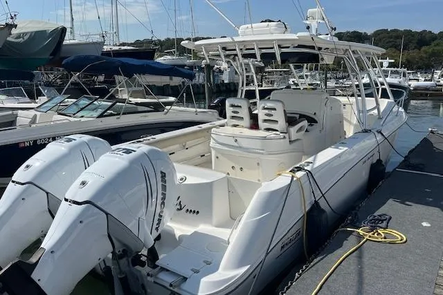 Slide: The Image of 2006 Boston Whaler 320 Outrage Cuddy Cabin docked with twin Mercury engines. - 14