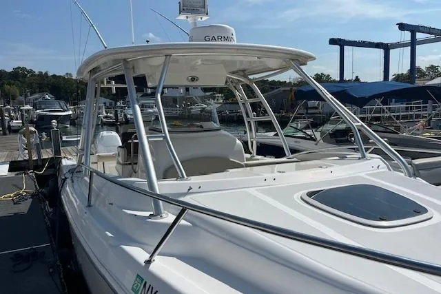 Slide: The Image of 2006 Boston Whaler 320 Outrage Cuddy Cabin docked at marina, featuring Garmin equipment. - 18