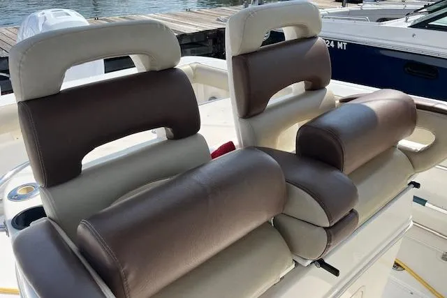 Slide: The Image of 2006 Boston Whaler 320 Outrage Cuddy Cabin boat seats, brown and beige leather, docked. - 20