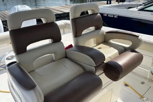 Slide: The Image of 2006 Boston Whaler 320 Outrage Cuddy Cabin boat seats, brown and cream leather, docked. - 21