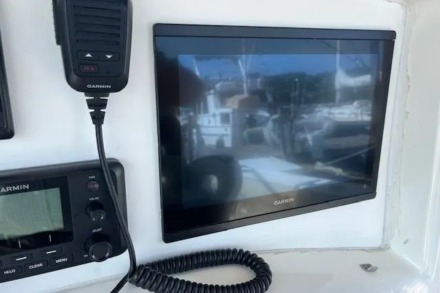 Slide: The Image of Garmin marine electronics on 2006 Boston Whaler 320 Outrage Cuddy Cabin dashboard. - 25