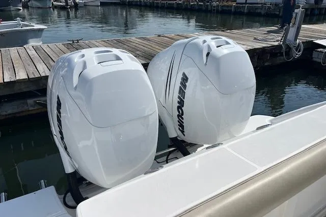 Slide: The Image of 2006 Boston Whaler 320 Outrage Cuddy Cabin with twin Mercury outboard engines at dock. - 29