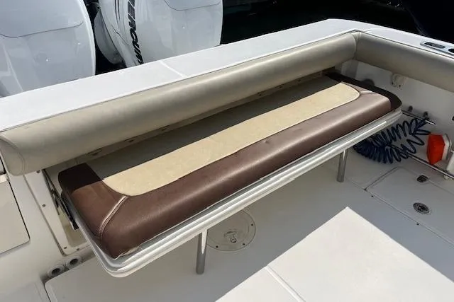 Slide: The Image of 2006 Boston Whaler 320 Outrage Cuddy Cabin boat seat with brown and beige upholstery. - 30