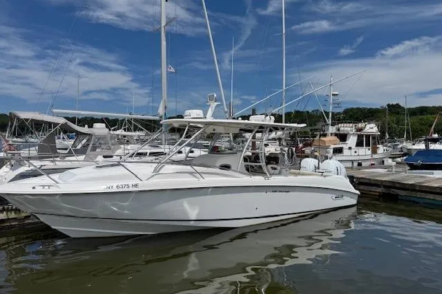 Slide: The Image of 2006 Boston Whaler 320 Outrage Cuddy Cabin docked at marina under blue sky. - 9