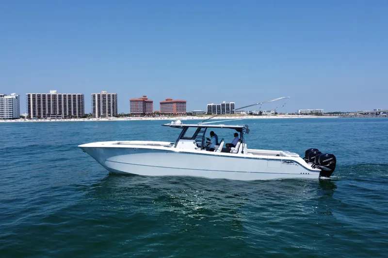 Slide: The Image of Invincible 46 Catamaran 2022 cruising near coastal city skyline on a sunny day. - 10