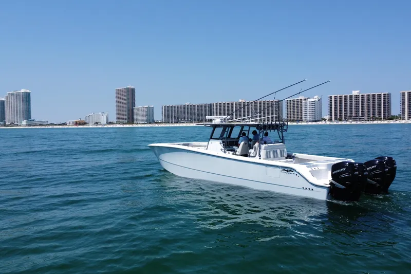 Slide: The Image of 2022 Invincible 46 Catamaran cruising near coastal city skyline. - 12