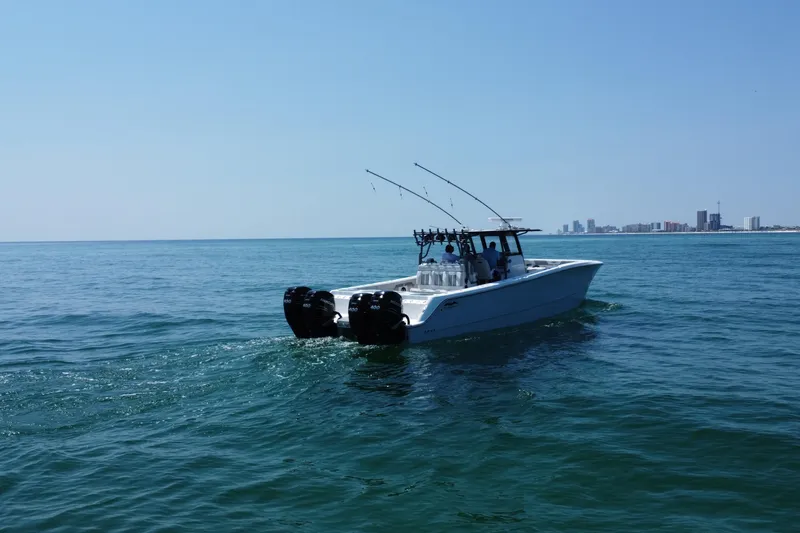 Slide: The Image of 2022 Invincible 46 Catamaran cruising on open water under clear blue sky. - 16