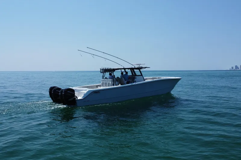 Slide: The Image of 2022 Invincible 46 Catamaran cruising on open water under clear blue sky. - 17