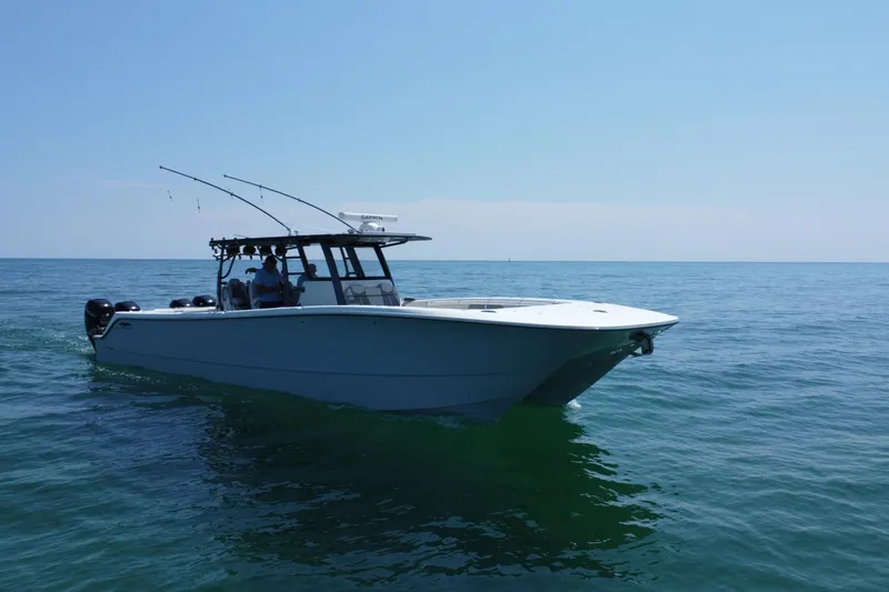 Slide: The Image of 2022 Invincible 46 Catamaran cruising on calm ocean waters under clear blue sky. - 20