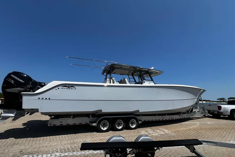 Slide: The Image of 2022 Invincible 46 Catamaran on calm water under a clear blue sky. - 31