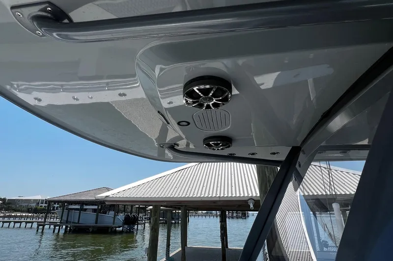 Slide: The Image of Luxurious 2022 Invincible 46 Catamaran with plush seating, docked by serene waters. - 32