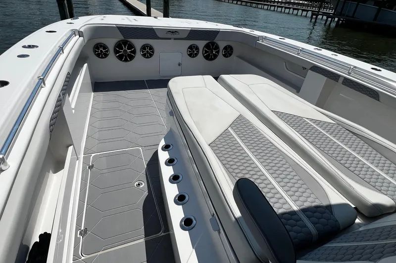 Slide: The Image of 2022 Invincible 46 Catamaran helm with modern controls and seating, dockside view. - 36