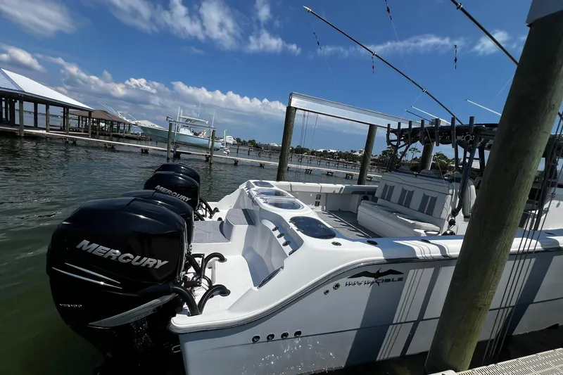 Slide: The Image of 2022 Invincible 46 Catamaran with luxurious seating, cruising on open water. - 37