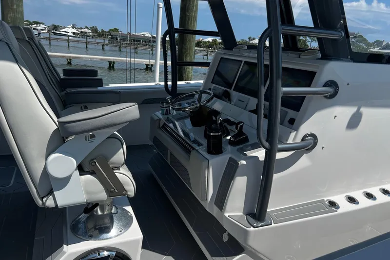 Slide: The Image of 2022 Invincible 46 Catamaran cruising on clear waters, featuring advanced navigation systems. - 38
