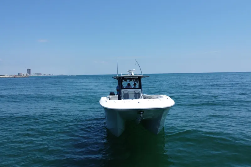 Slide: The Image of 2022 Invincible 46 Catamaran on open sea with city skyline in background. - 4