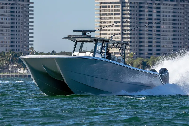 Slide: The Image of 2022 Invincible 46 Catamaran with four powerful outboard engines cruising on open water. - 41