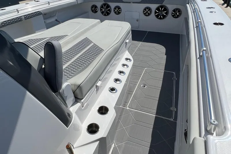 Slide: The Image of Luxurious 2022 Invincible 46 Catamaran with plush seating, docked by the serene waterfront. - 46