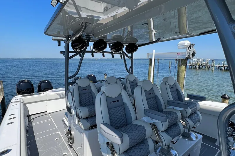 Slide: The Image of 2022 Invincible 46 Catamaran docked, showcasing sleek design and spacious seating. - 48