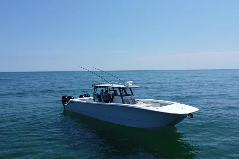 Slide: The Image of 2022 Invincible 46 Catamaran on calm ocean waters under clear blue sky. - 5