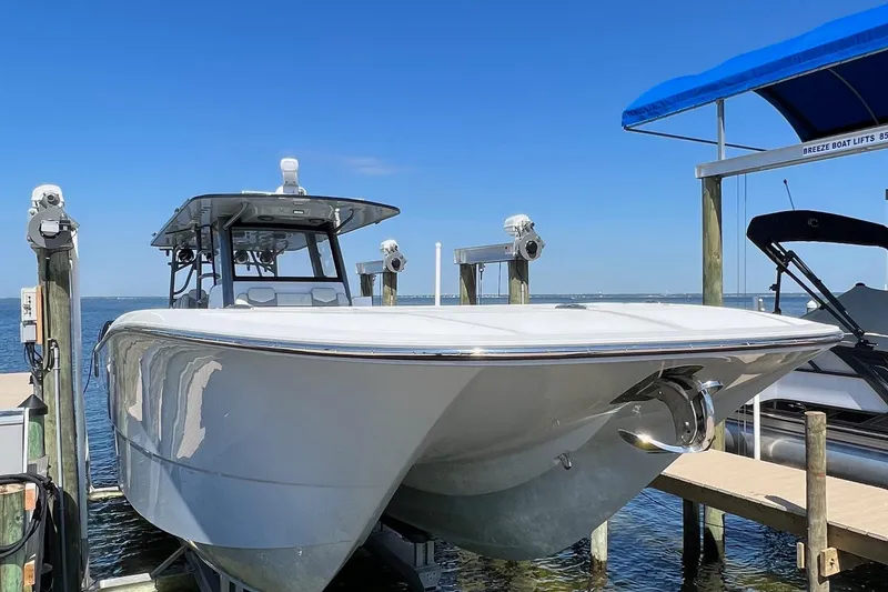 Slide: The Image of 2022 Invincible 46 Catamaran docked, featuring sleek design and modern seating. - 52