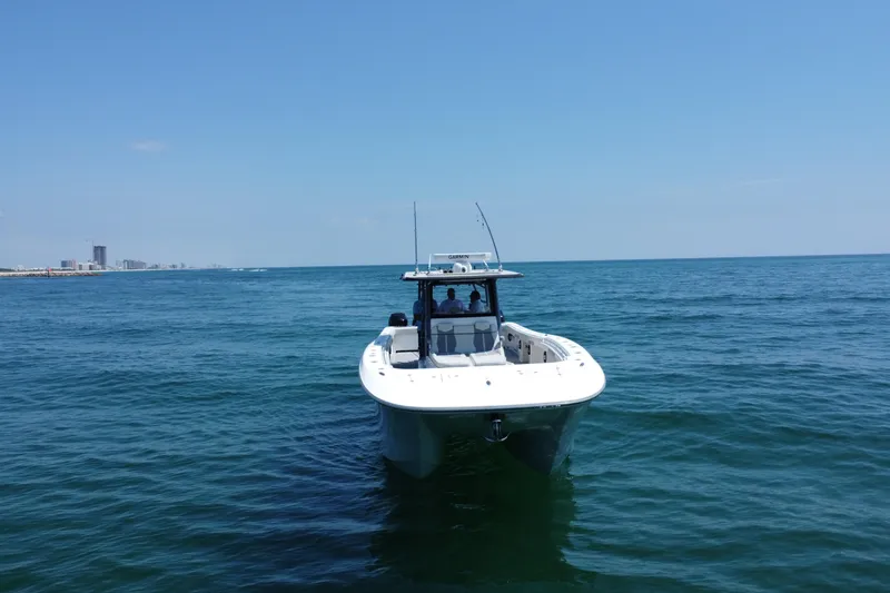 Slide: The Image of 2022 Invincible 46 Catamaran on open sea with city skyline in background. - 7