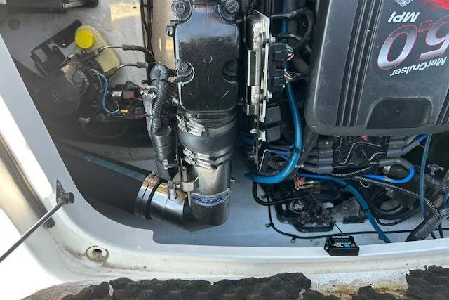 Slide: The Image of Engine compartment of a 2005 Chris-Craft Speedster boat, showcasing mechanical components and wiring. - 11
