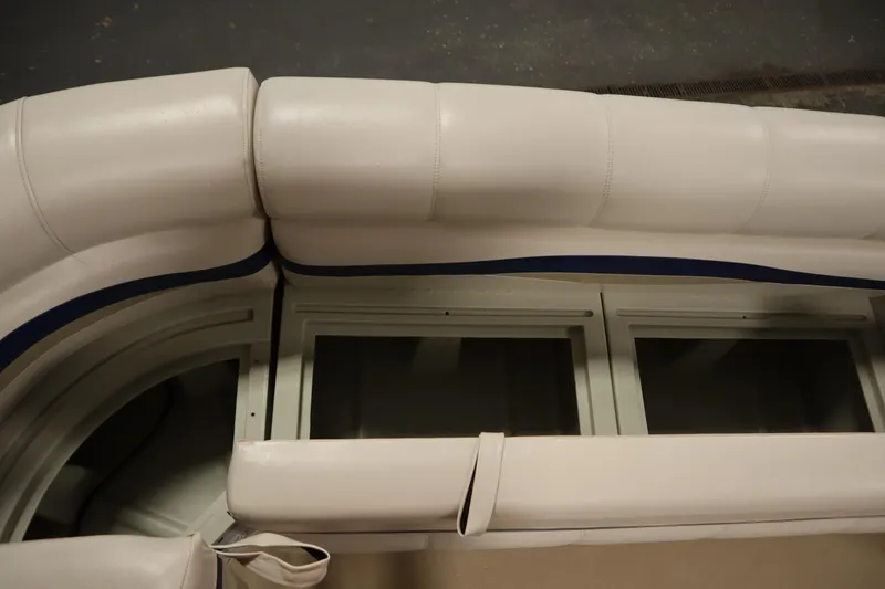 Slide: The Image of 2014 Sun Tracker Party Barge 24 DLX interior seating with storage compartments. - 14