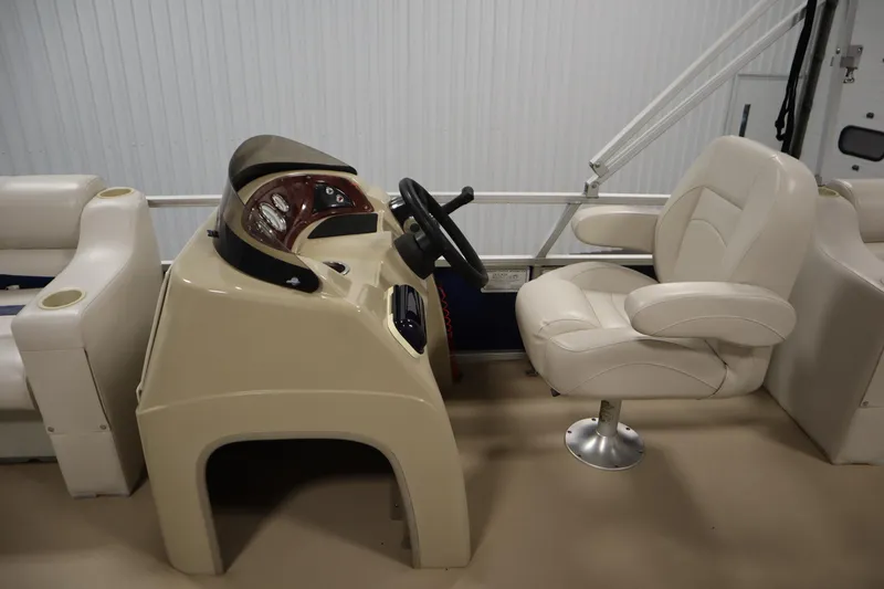 Slide: The Image of 2014 Sun Tracker Party Barge 24 DLX helm with beige captain's chair and console. - 15