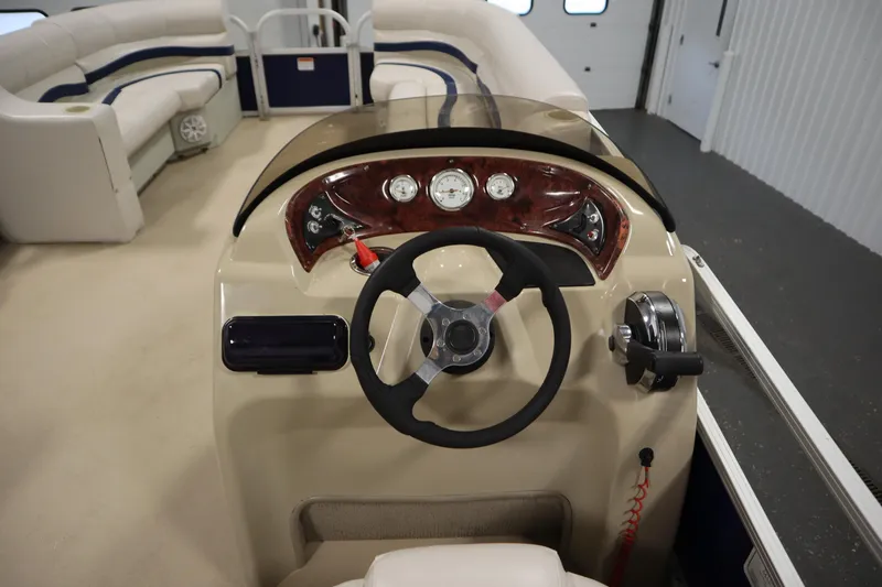 Slide: The Image of 2014 Sun Tracker Party Barge 24 DLX steering console with gauges and controls. - 17